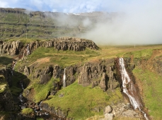 Waterfalls tumbling off the edge of the mountain north of Seyðisfjörður, in East Iceland
